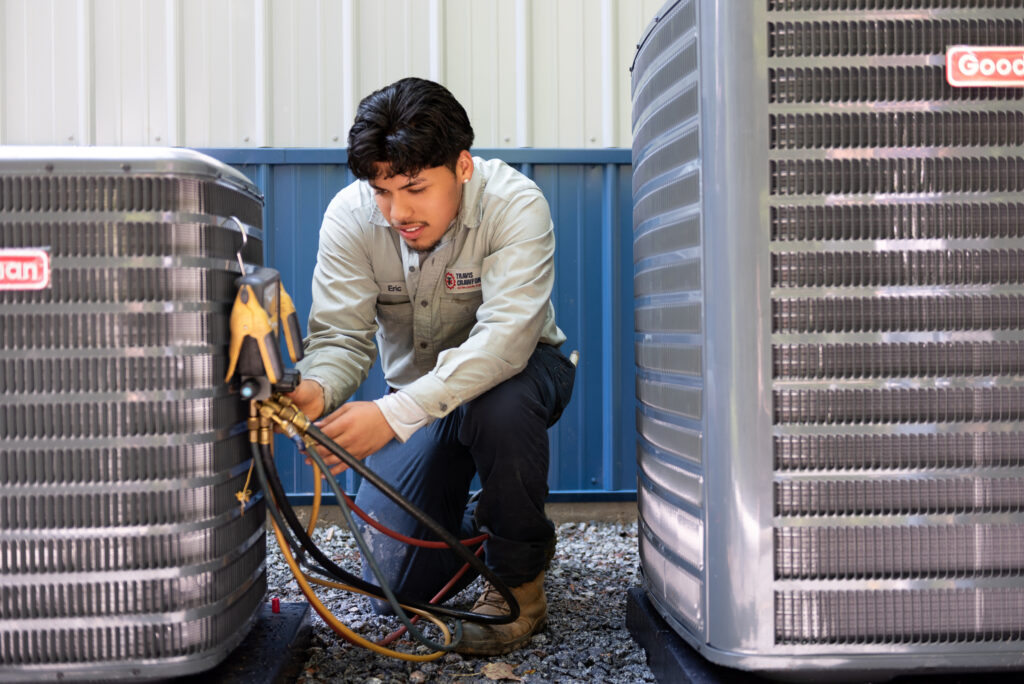 a Travis Crawford HVAC technician performs a tune-up on an air conditioner or heat pump