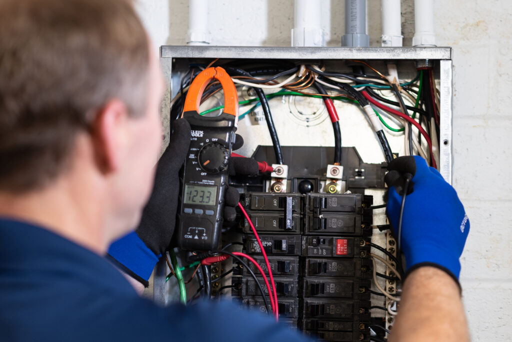 a Travis Crawford electrician inspects an electrical panel in a Charlotte, NC home