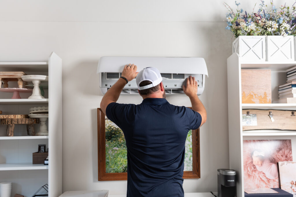 a Travis Crawford HVAC technician does maintenance on a ductless mini-split system in Charlotte, NC
