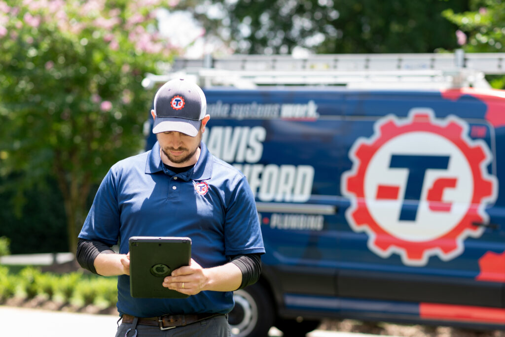 a Travis Crawford service technician walking up to a Charlotte, NC home for a maintenance visit as part of the Protection Club plan