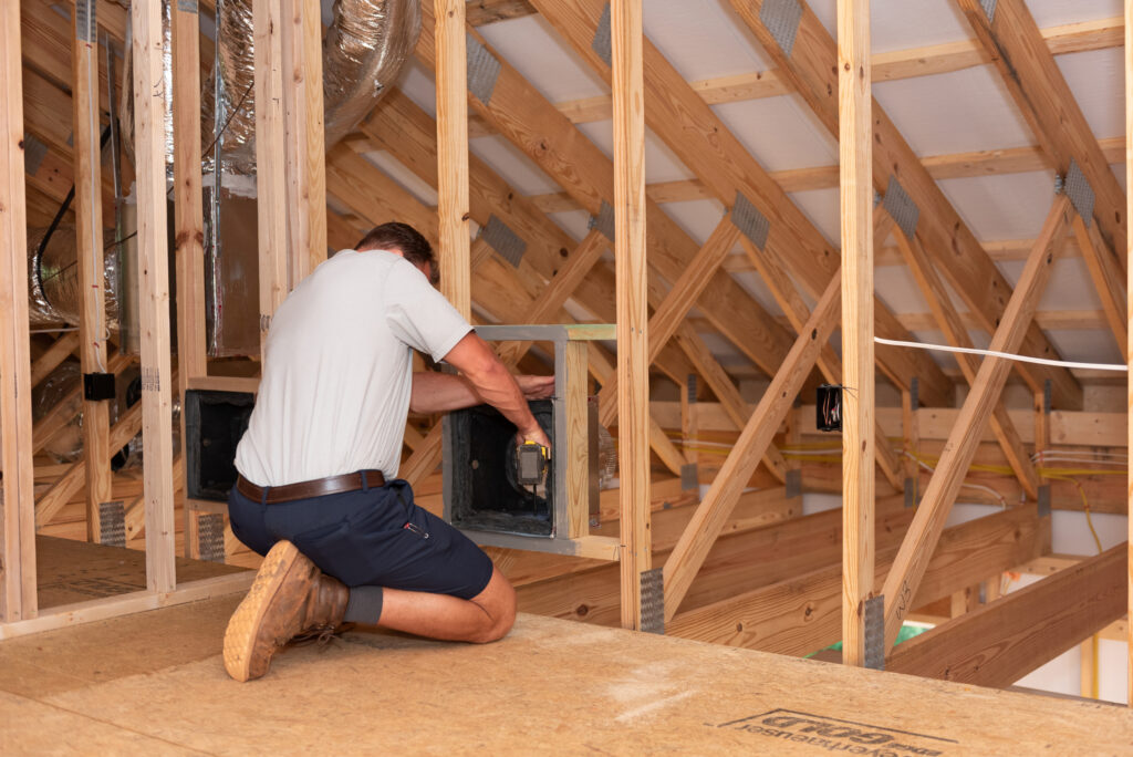 a Travis Crawford technician prepares to install ductwork in a home in Charlotte, NC