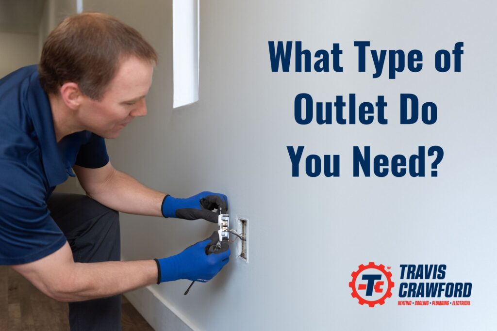 an electrician from Travis Crawford installs a new outlet in an office in Charlotte, NC